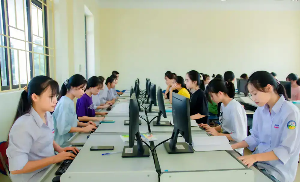 Group of students learning on classic 8-bit computers